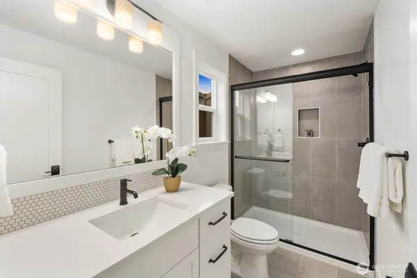 a bathroom with a sink toilet and shower