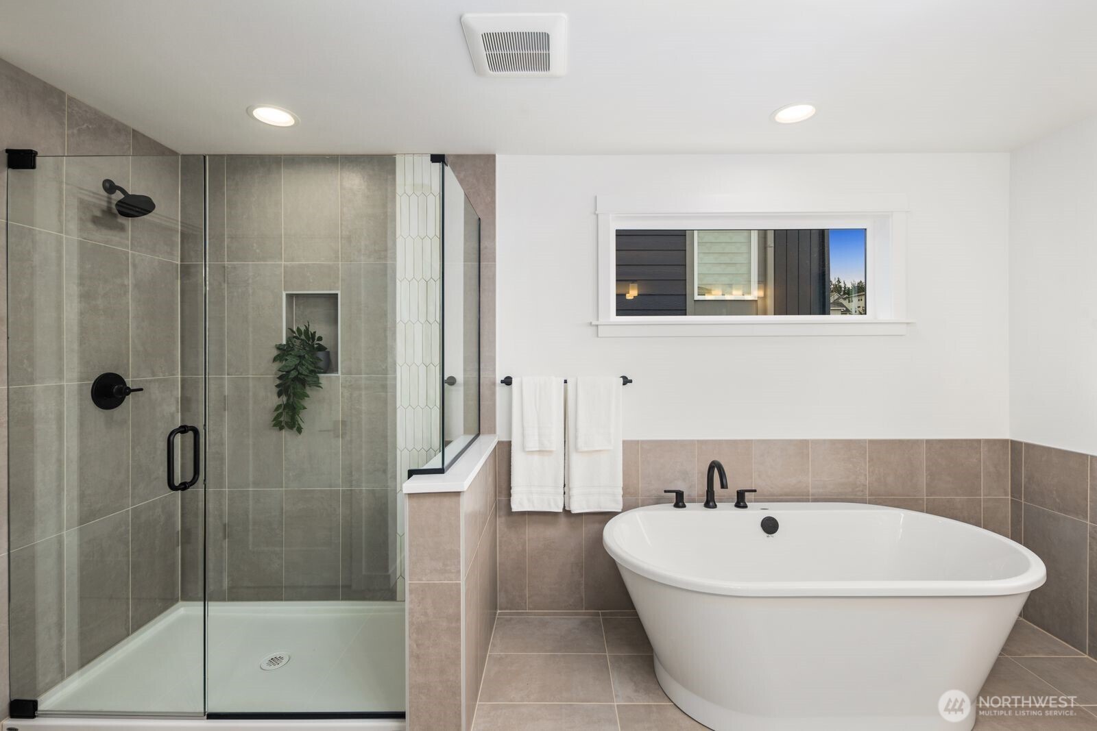 4123 220th Place Southeast Bothell, WA 98021 - Photo 21 of 25 a white bath tub sitting next to a bathroom
