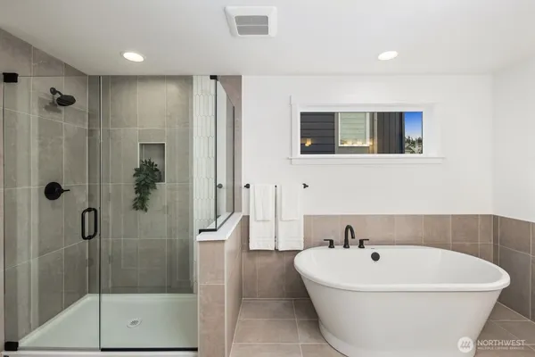 a white bath tub sitting next to a bathroom