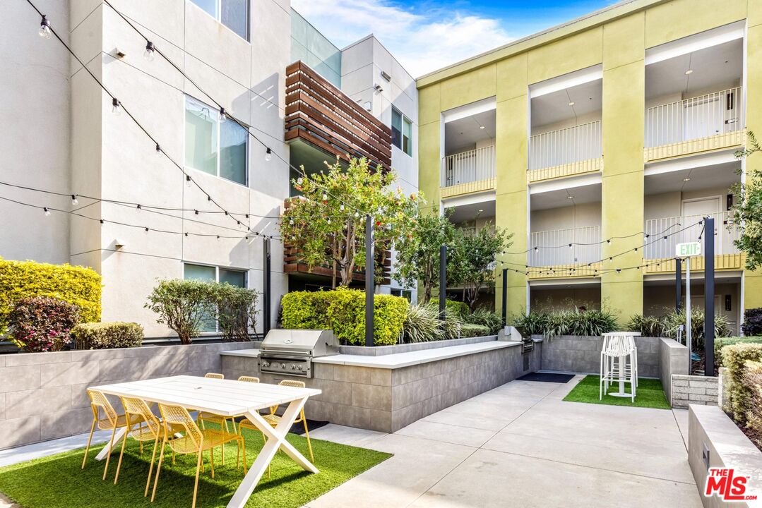 12760 Millennium Drive, Unit NB107 Los Angeles, CA 90094 - Photo 18 of 38 a view of a patio with couches table and chairs potted plants