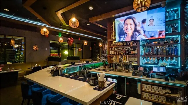 a living room with patio furniture and a large window