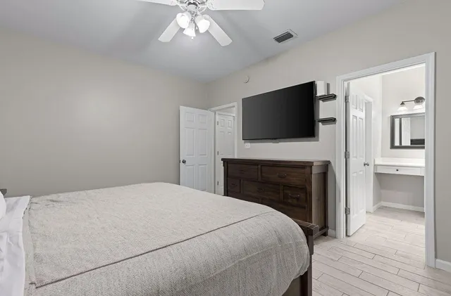 a bedroom with a bed and a chandelier