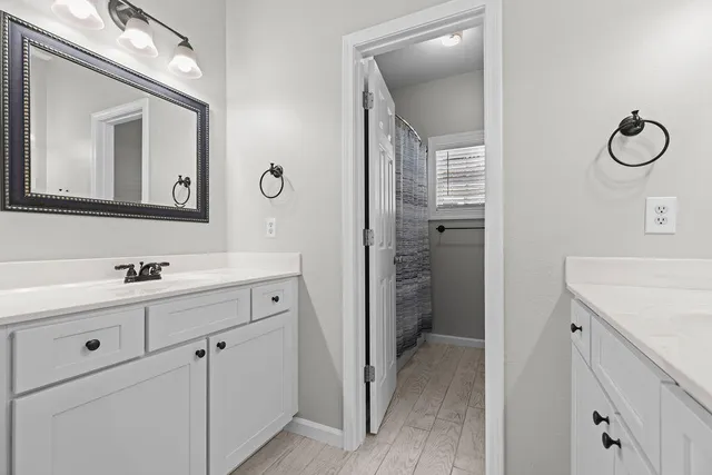 a spacious bathroom with a double vanity sink mirror and toilet
