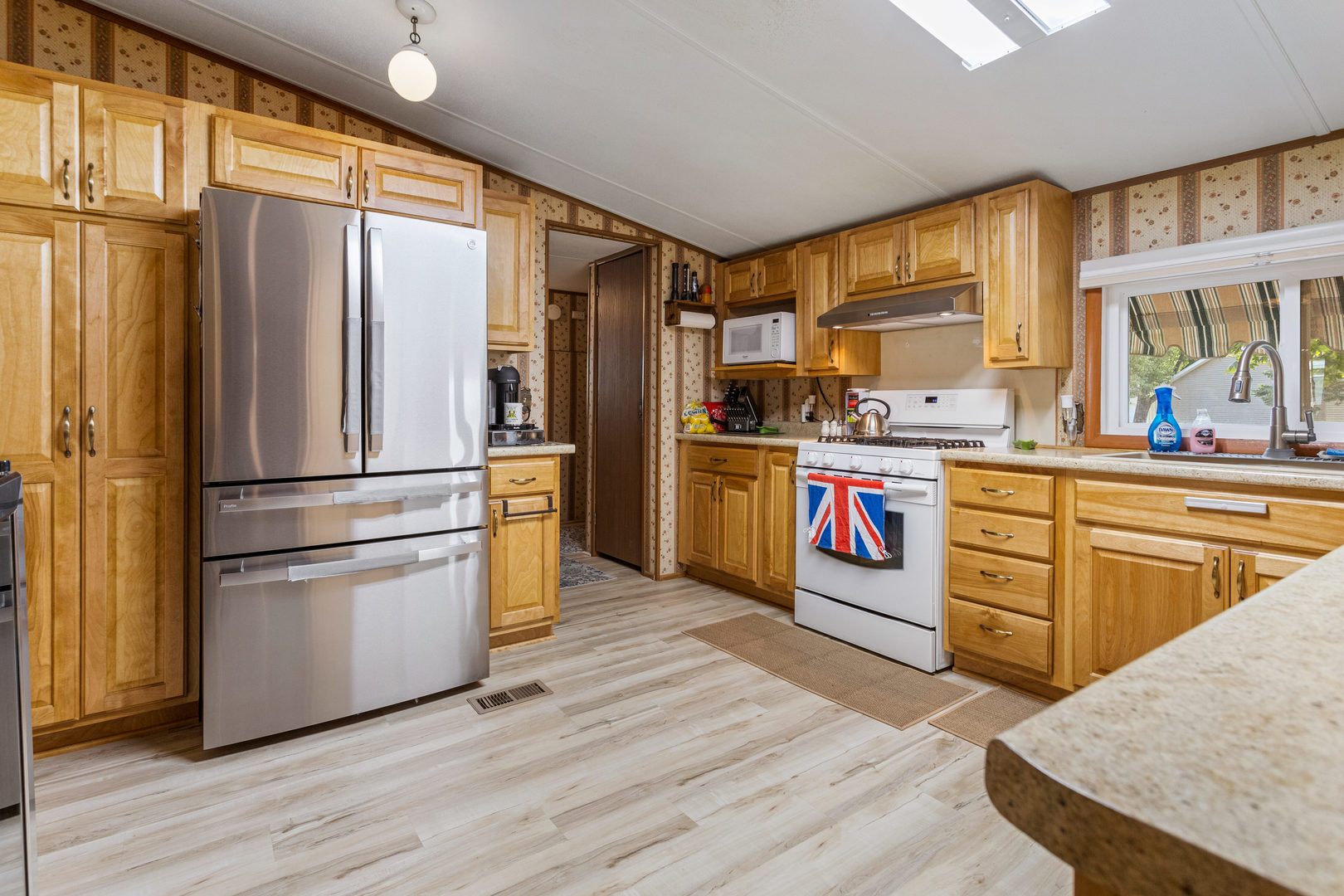 628 Williamson Street Mahomet, IL 61853 - Photo 20 of 36 a kitchen with granite countertop stainless steel appliances a refrigerator cabinets and wooden floor