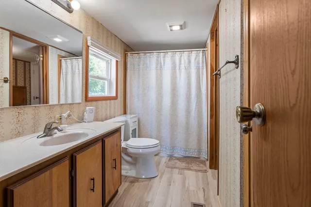 a bathroom with a sink toilet and shower