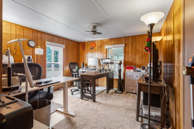 a view of a livingroom with workspace and a window