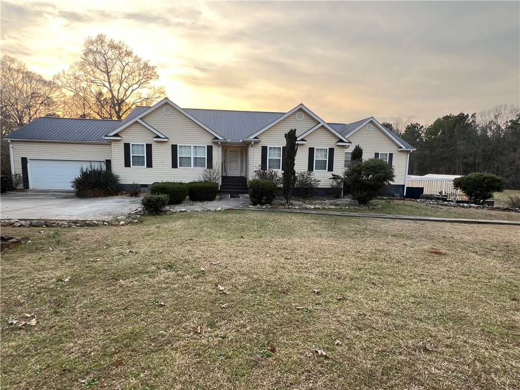 521 Calhoun Shores Parkway Calhoun Falls, SC 29628 - Photo 2 of 39 This charming home offers a spacious layout with a welcoming facade and lush greenery.