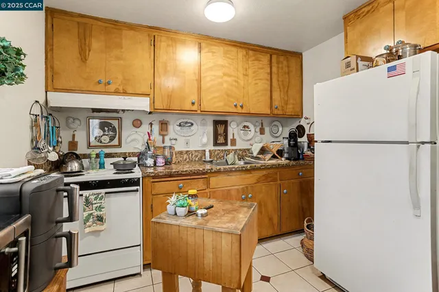 a kitchen with a refrigerator and a stove