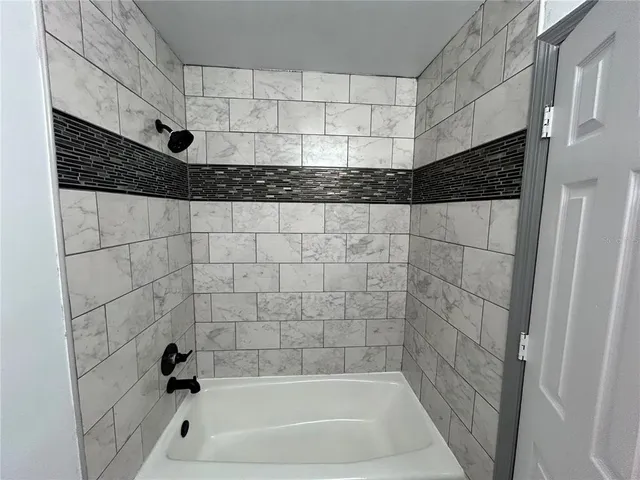 a bathroom with a bathtub and shower