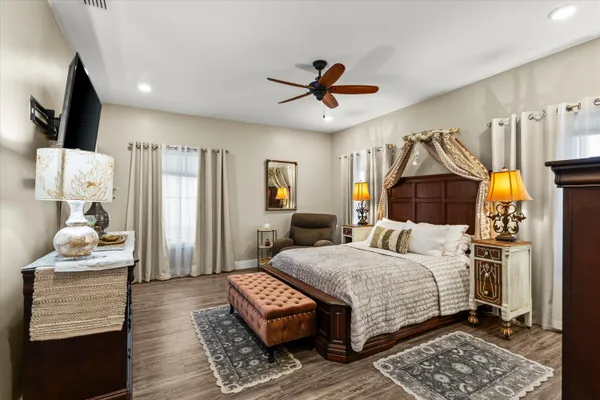 a bedroom with a bed and a flat screen tv