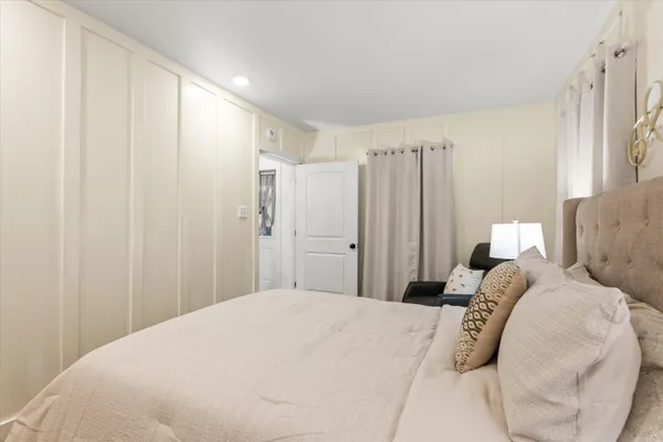 a bedroom with a bed and a couch