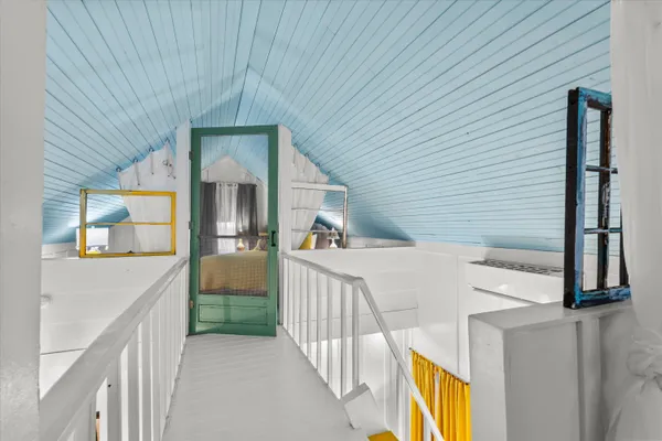 a view of a big house with a big yard and large trees