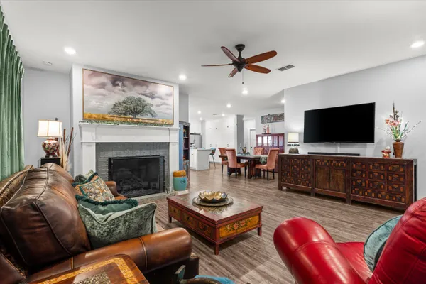 a living room with furniture a flat screen tv and a fireplace