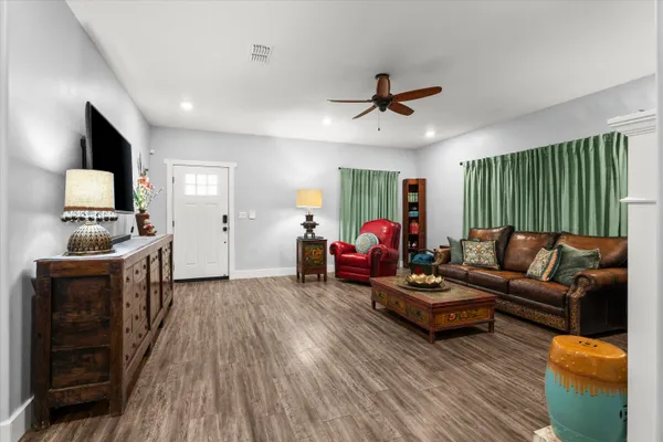 a view of a dining room with furniture a kitchen and chandelier