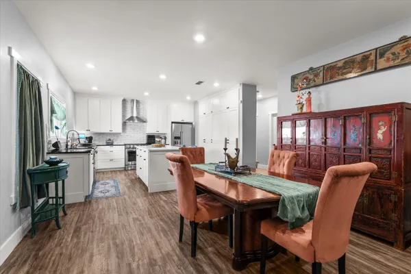 a kitchen with a sink appliances and wooden floor