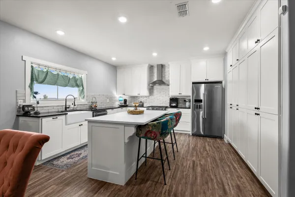 a view of kitchen with cabinets and wooden floor