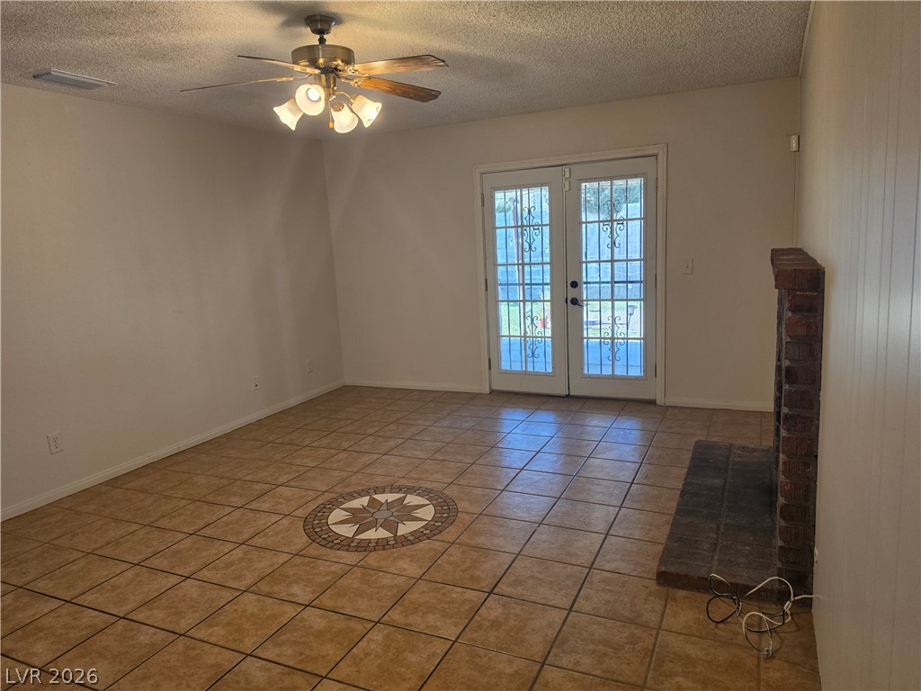 5289 Reeder Circle Las Vegas, NV 89119 - Photo 12 of 40 A classic brick fireplace anchors this spacious tiled living area opening to the backyard.