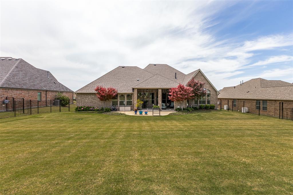 506 Life Spring Drive Rockwall, TX 75087 - Photo 35 of 36 a front view of a house with swimming pool and trees in the background