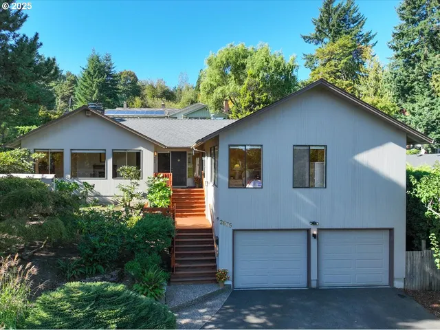 a front view of a house with a garden