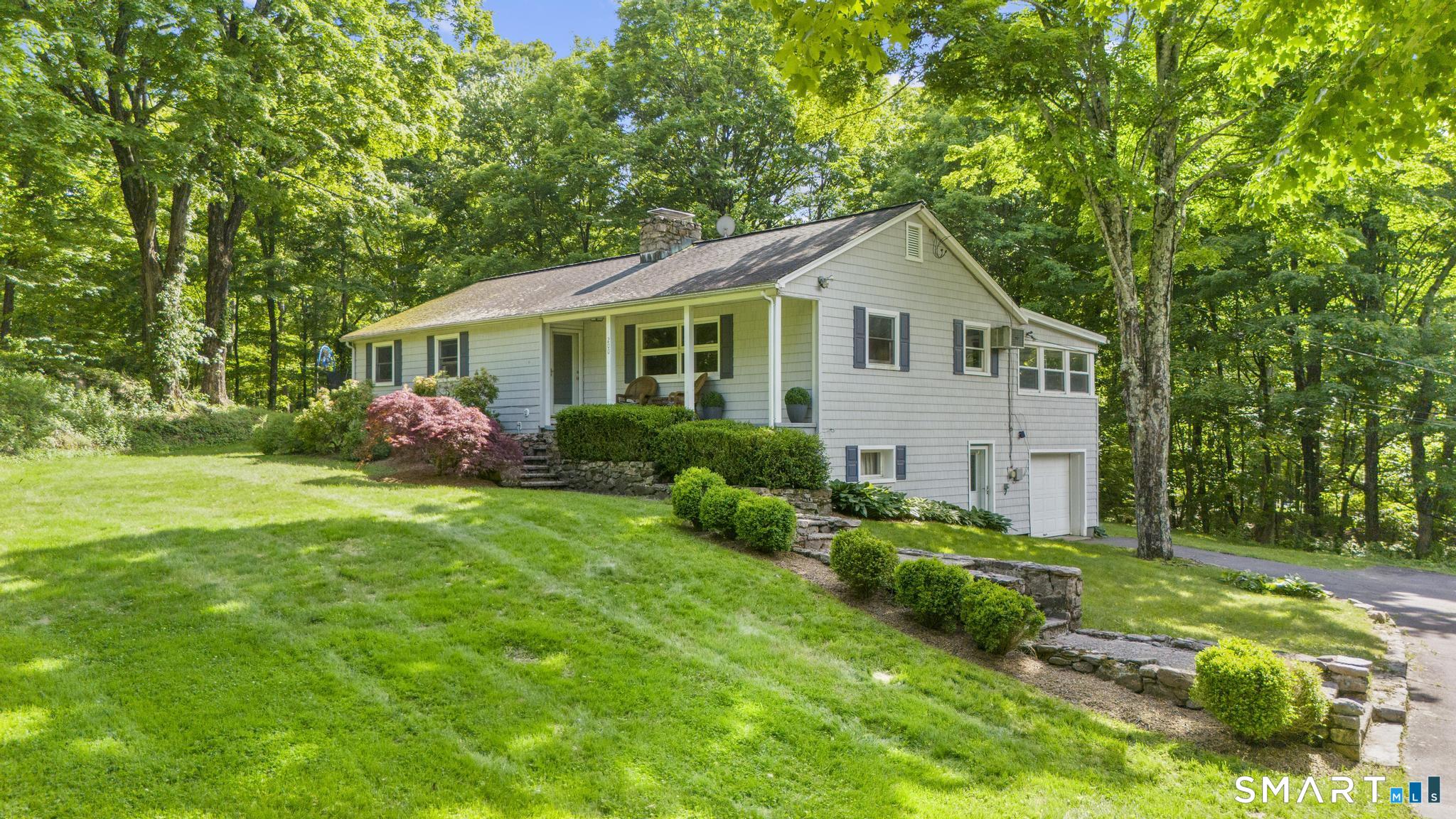 a house with green field in front of it