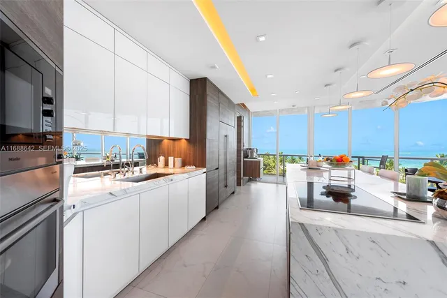 a kitchen with counter top space a sink and appliances