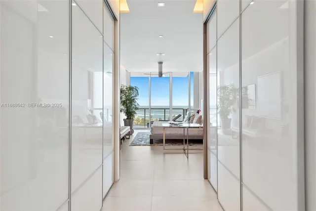 a view of a kitchen with kitchen island and stainless steel appliances