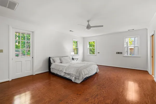 a view of hallway with window and hardwood floor