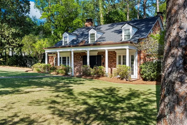 a front view of house with yard outdoor seating and green space