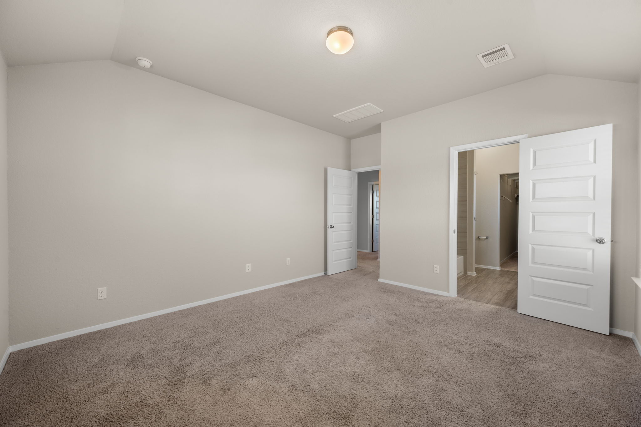 215 Lake Placid Run Elgin, TX 78621 - Photo 15 of 29 Plush carpeting and vaulted ceilings define this comfortable bedroom space.