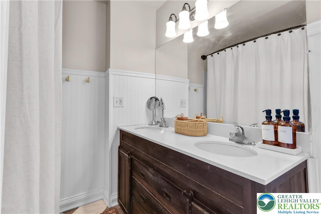 2145 Henderson Street Bethlehem, PA 18017 - Photo 23 of 42 a bathroom with a sink vanity and a mirror
