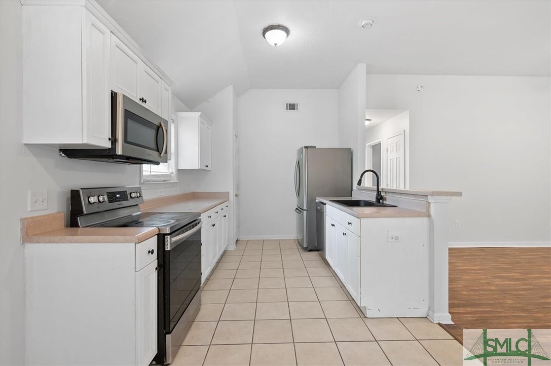 305 Elm Road Ellabell, GA 31308 - Photo 10 of 44 White cabinetry and tall ceilings.