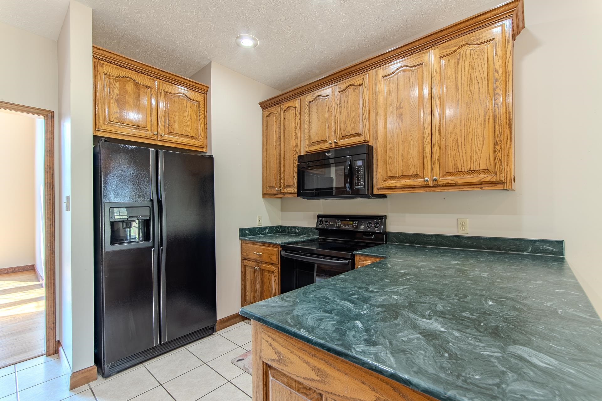 200 Grandview Circle Adamsville, TN 38310 - Photo 14 of 40 a kitchen with stainless steel appliances granite countertop a refrigerator and a stove top oven