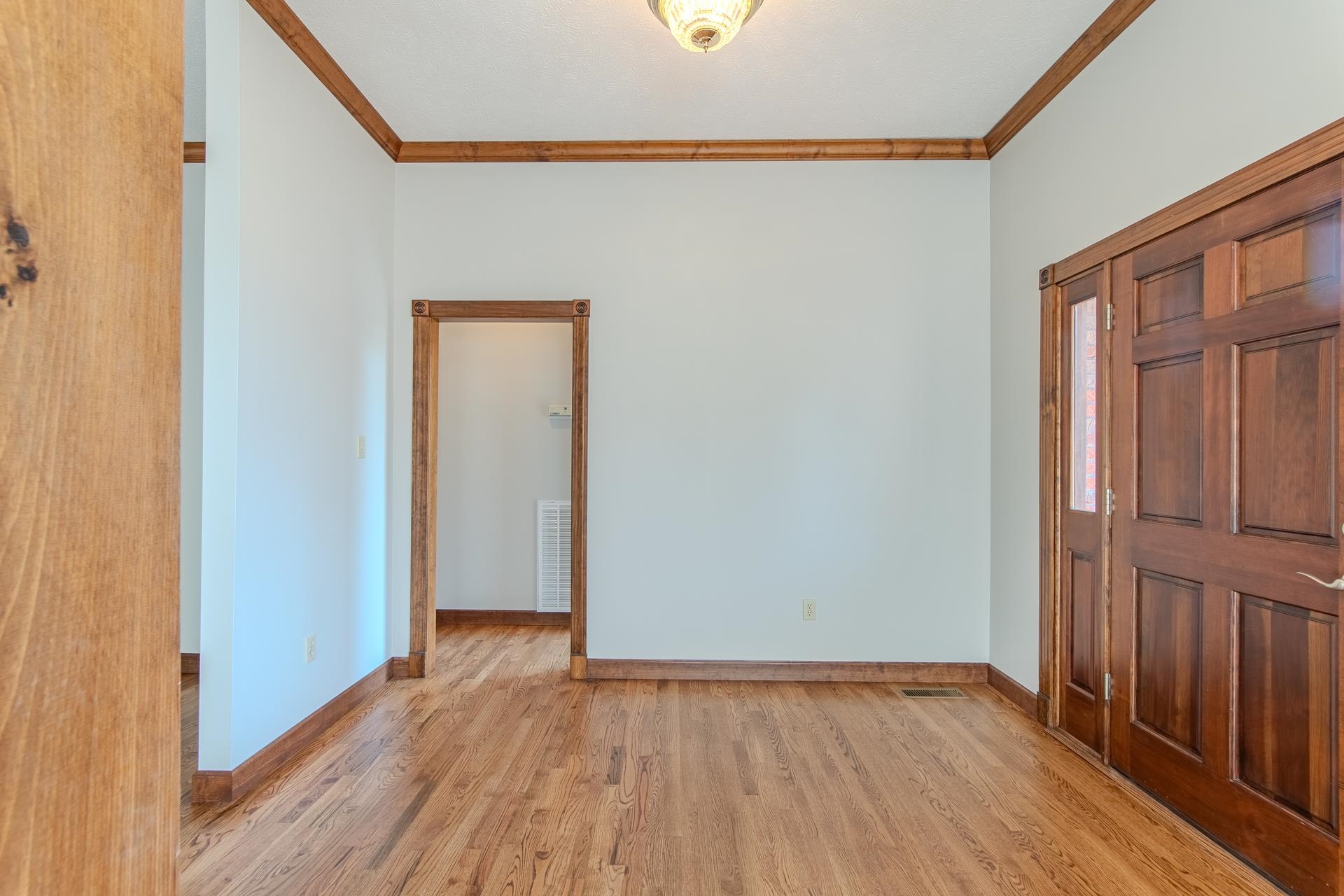 200 Grandview Circle Adamsville, TN 38310 - Photo 27 of 40 a view of an empty room with wooden floor and a window