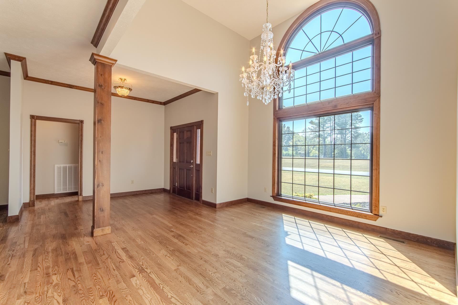 200 Grandview Circle Adamsville, TN 38310 - Photo 5 of 40 a view of an empty room with wooden floor and a window