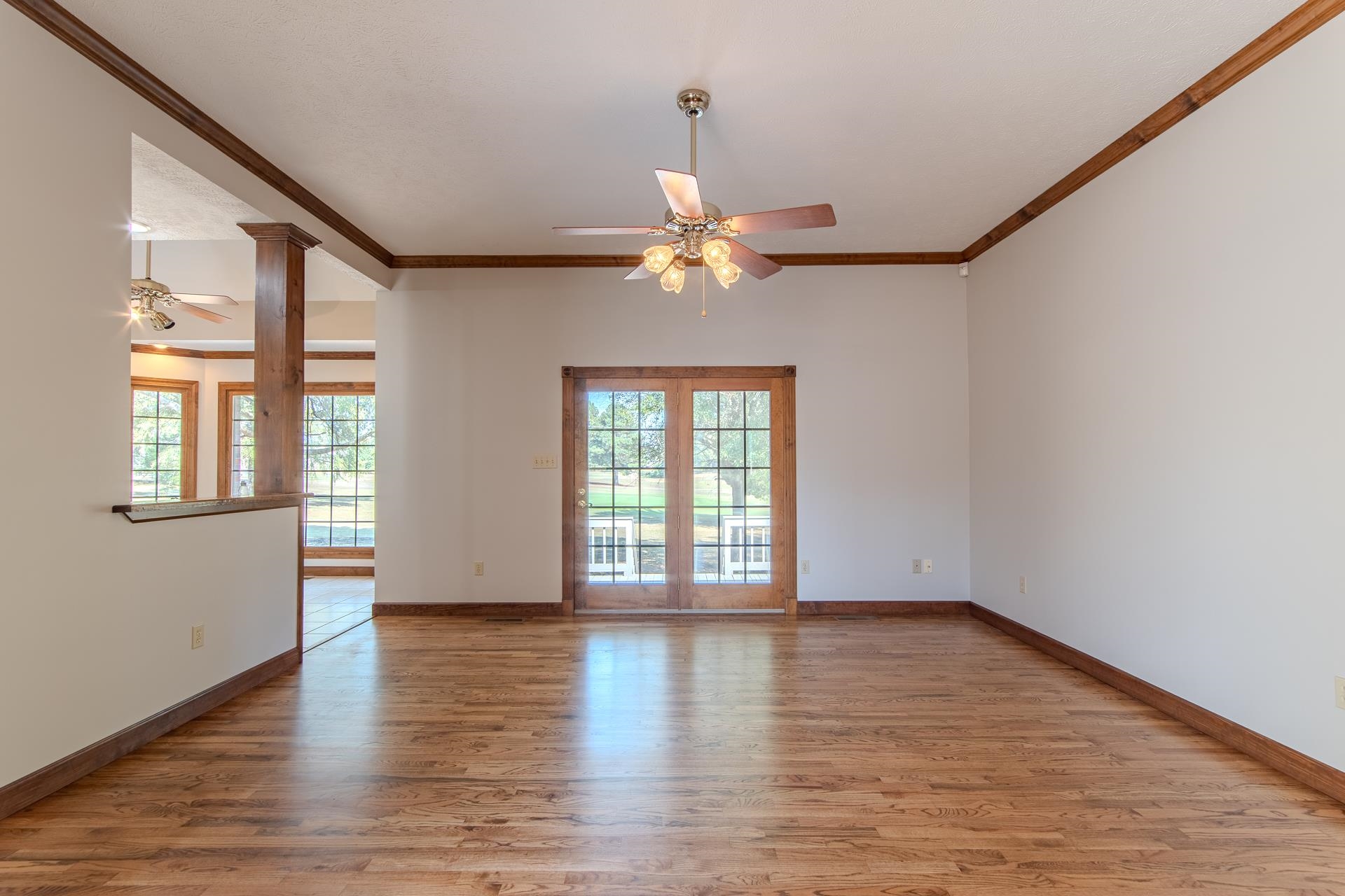 200 Grandview Circle Adamsville, TN 38310 - Photo 10 of 40 a view of an empty room with window and wooden floor