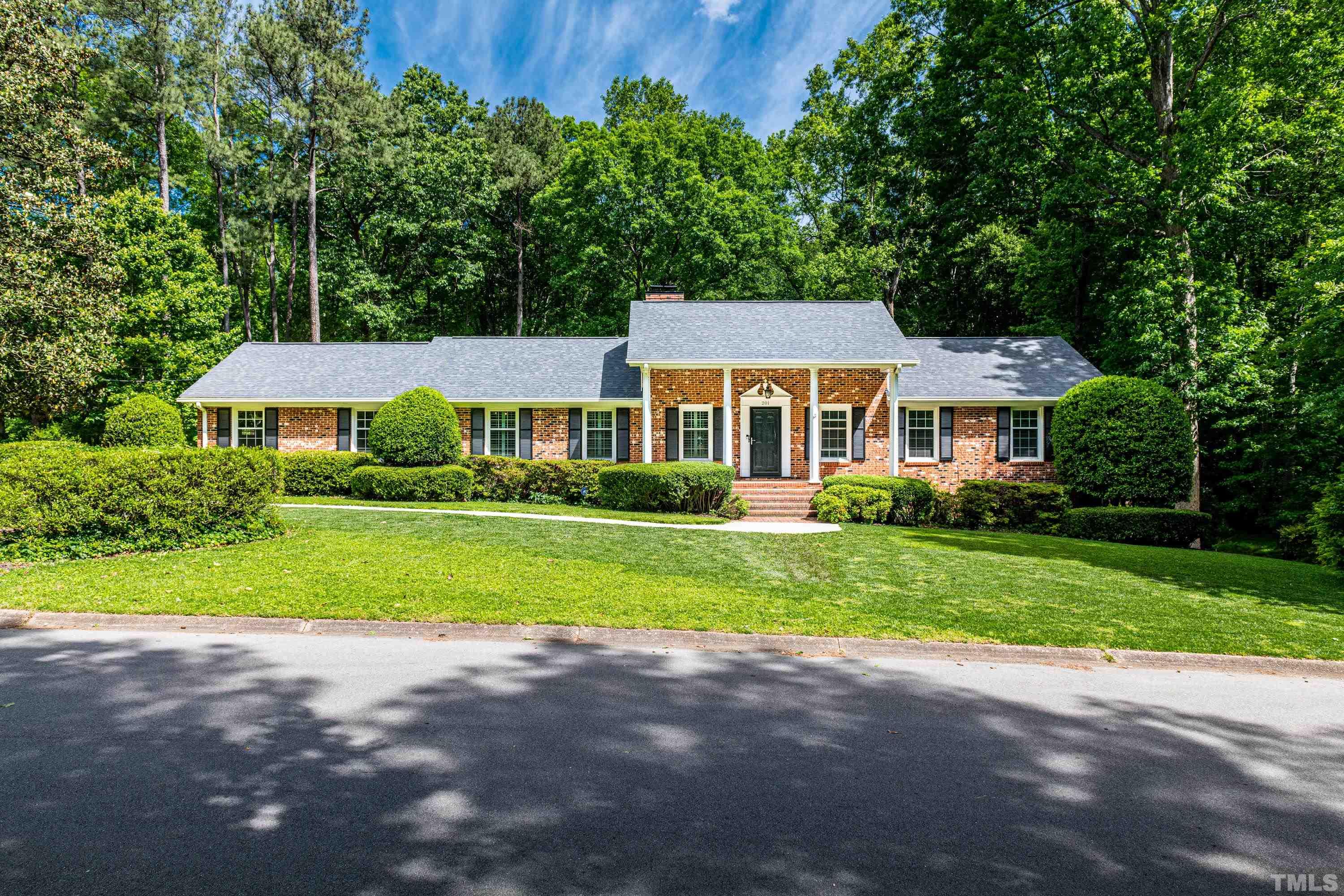 201 Chatterson Drive Raleigh, NC 27615 - Photo 1 of 44 a front view of a house with a yard and garage