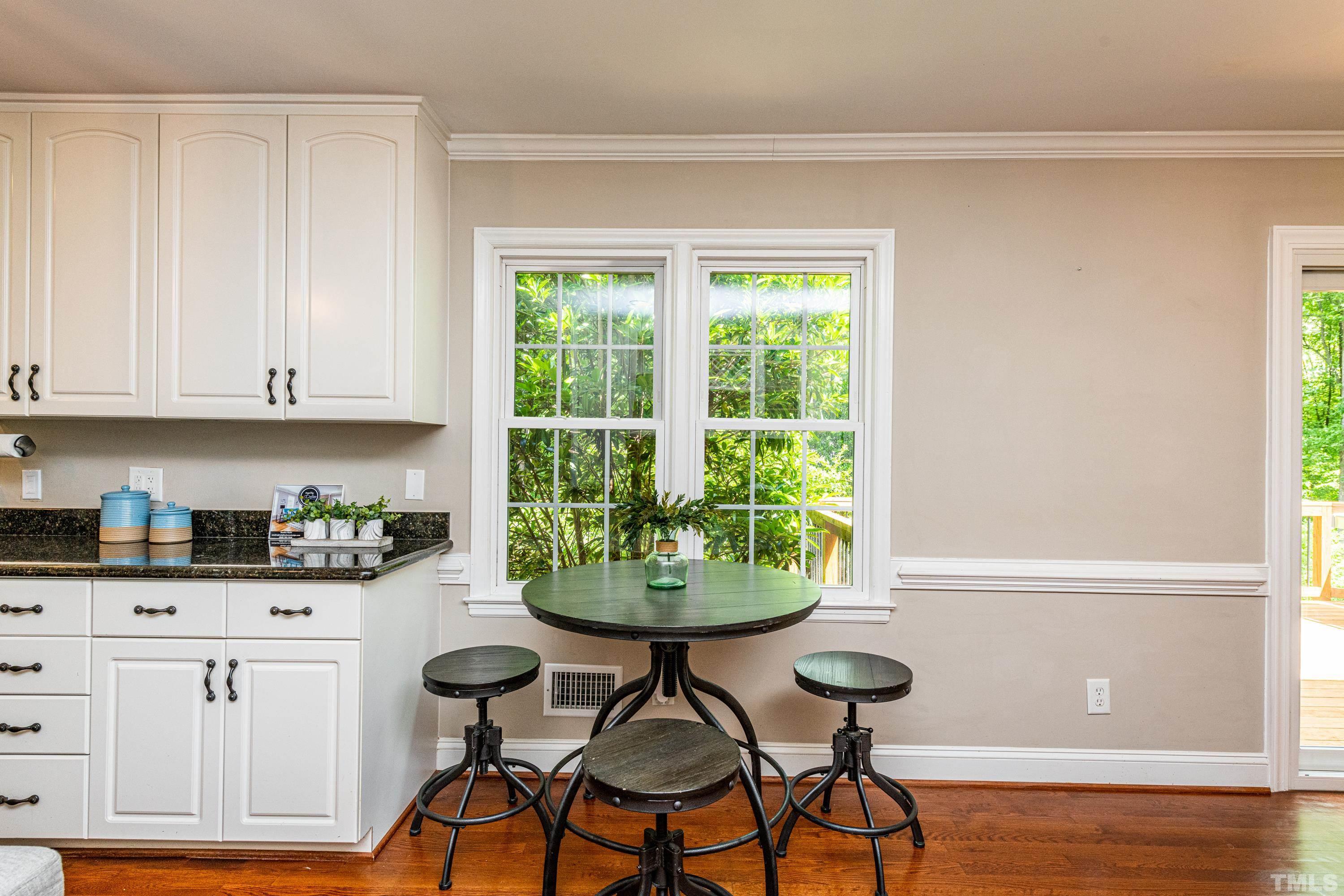 201 Chatterson Drive Raleigh, NC 27615 - Photo 11 of 44 a kitchen with stainless steel appliances a table and chairs in it