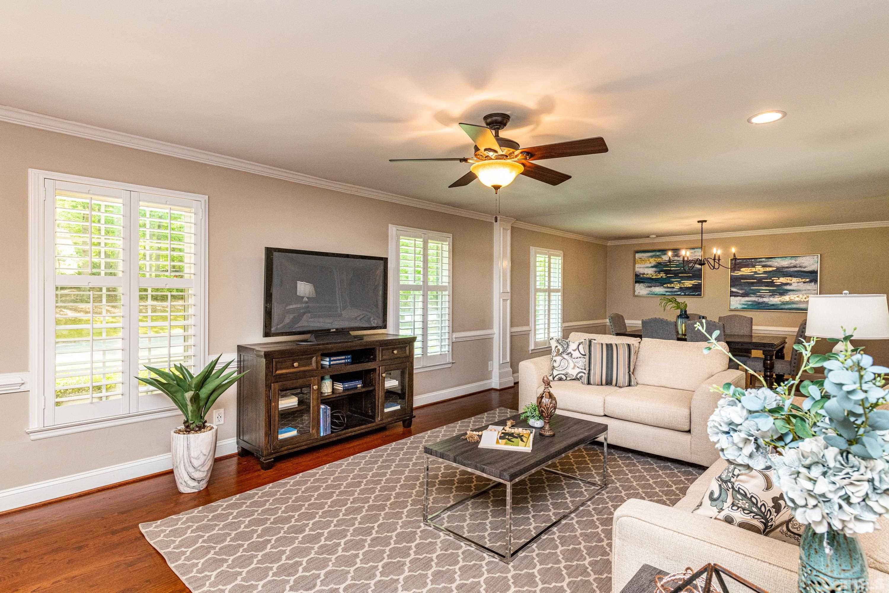 201 Chatterson Drive Raleigh, NC 27615 - Photo 12 of 44 a living room with furniture and a flat screen tv