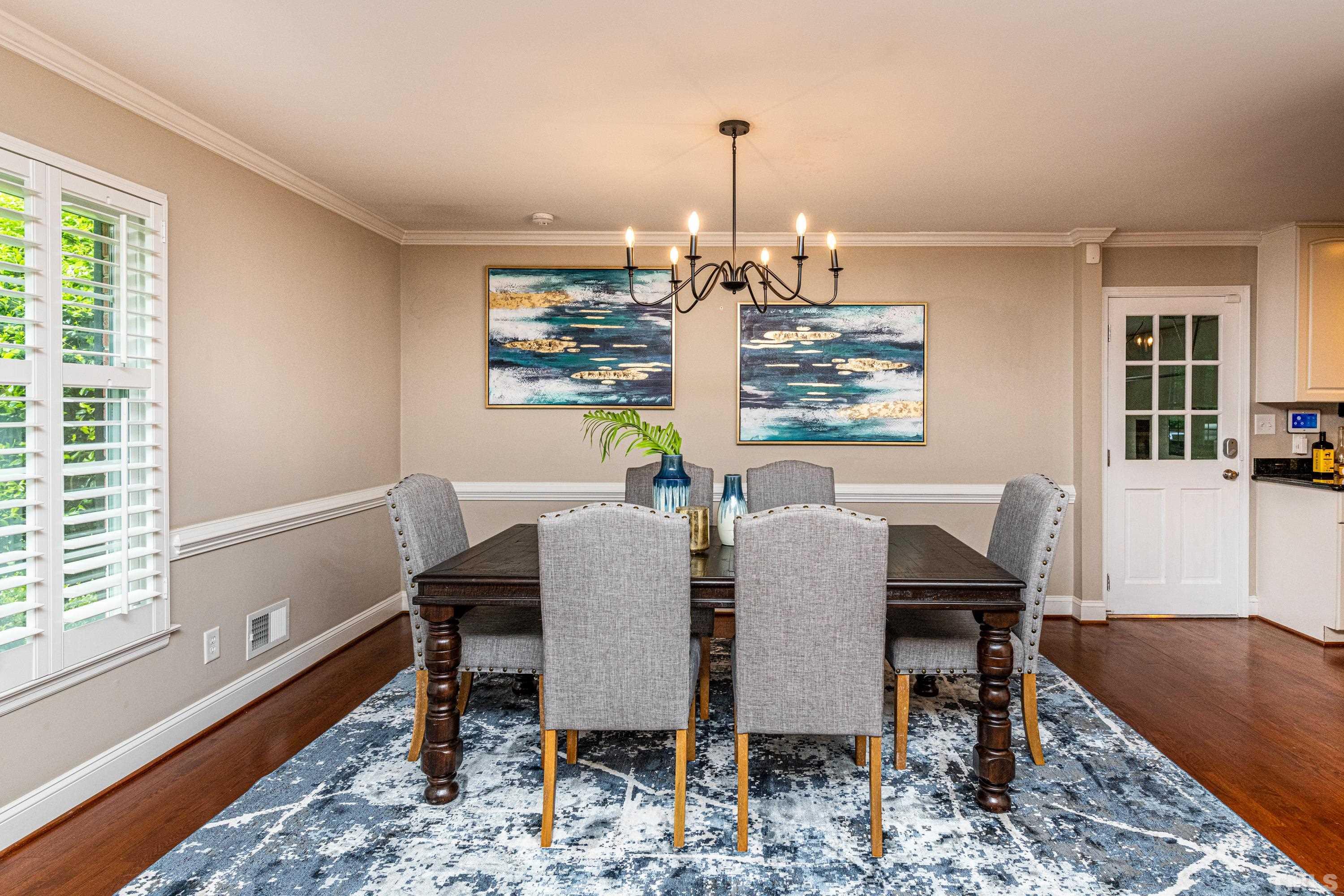 201 Chatterson Drive Raleigh, NC 27615 - Photo 16 of 44 a view of a dining room with furniture window and wooden floor