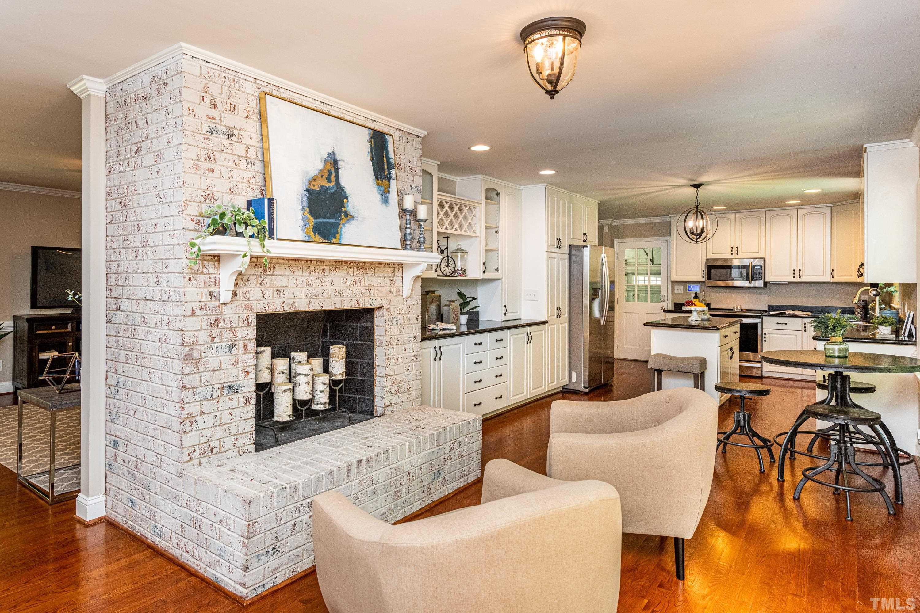 201 Chatterson Drive Raleigh, NC 27615 - Photo 19 of 44 a living room with furniture and a fireplace