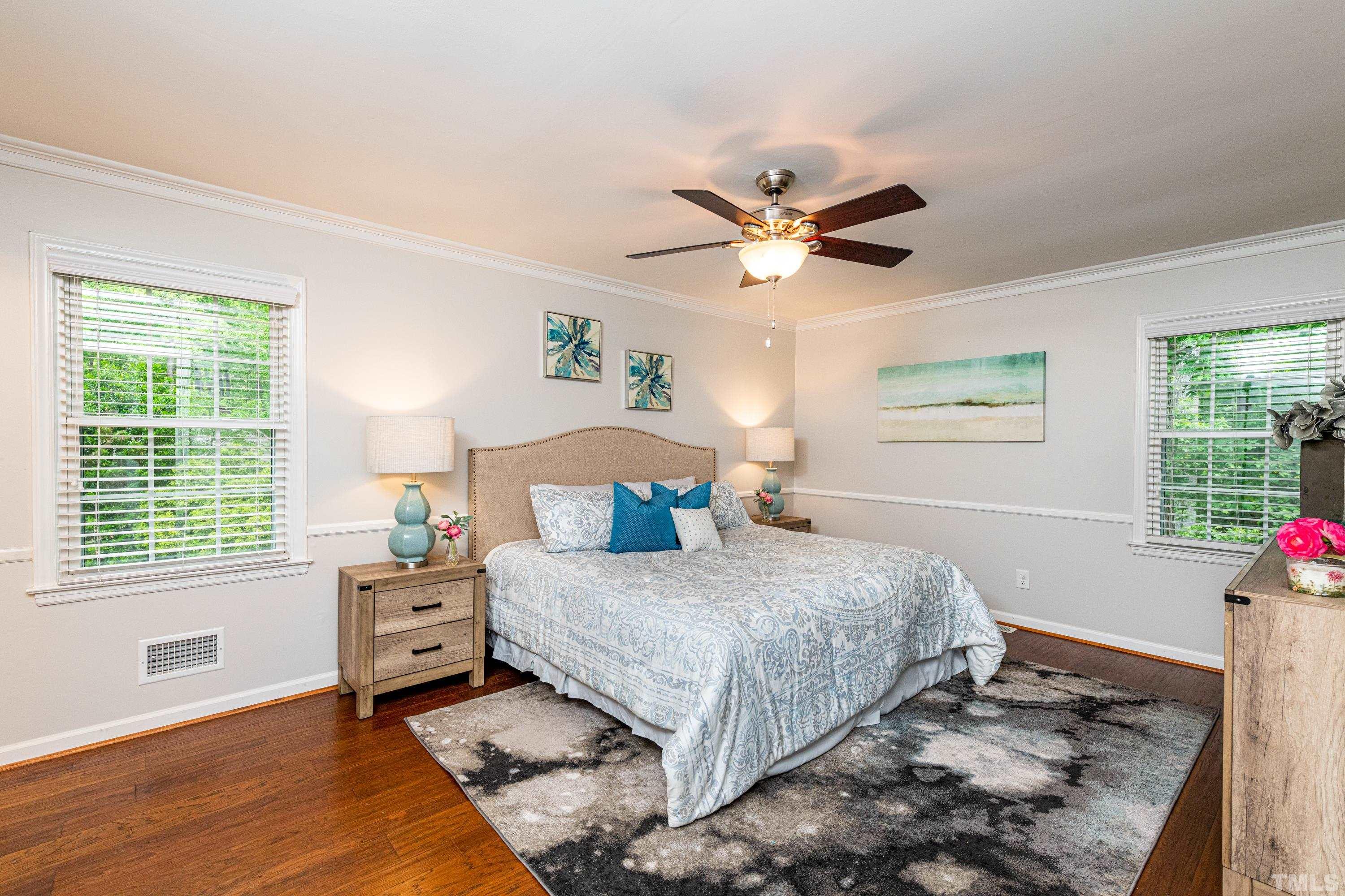201 Chatterson Drive Raleigh, NC 27615 - Photo 20 of 44 a bedroom with a bed chandelier and a window