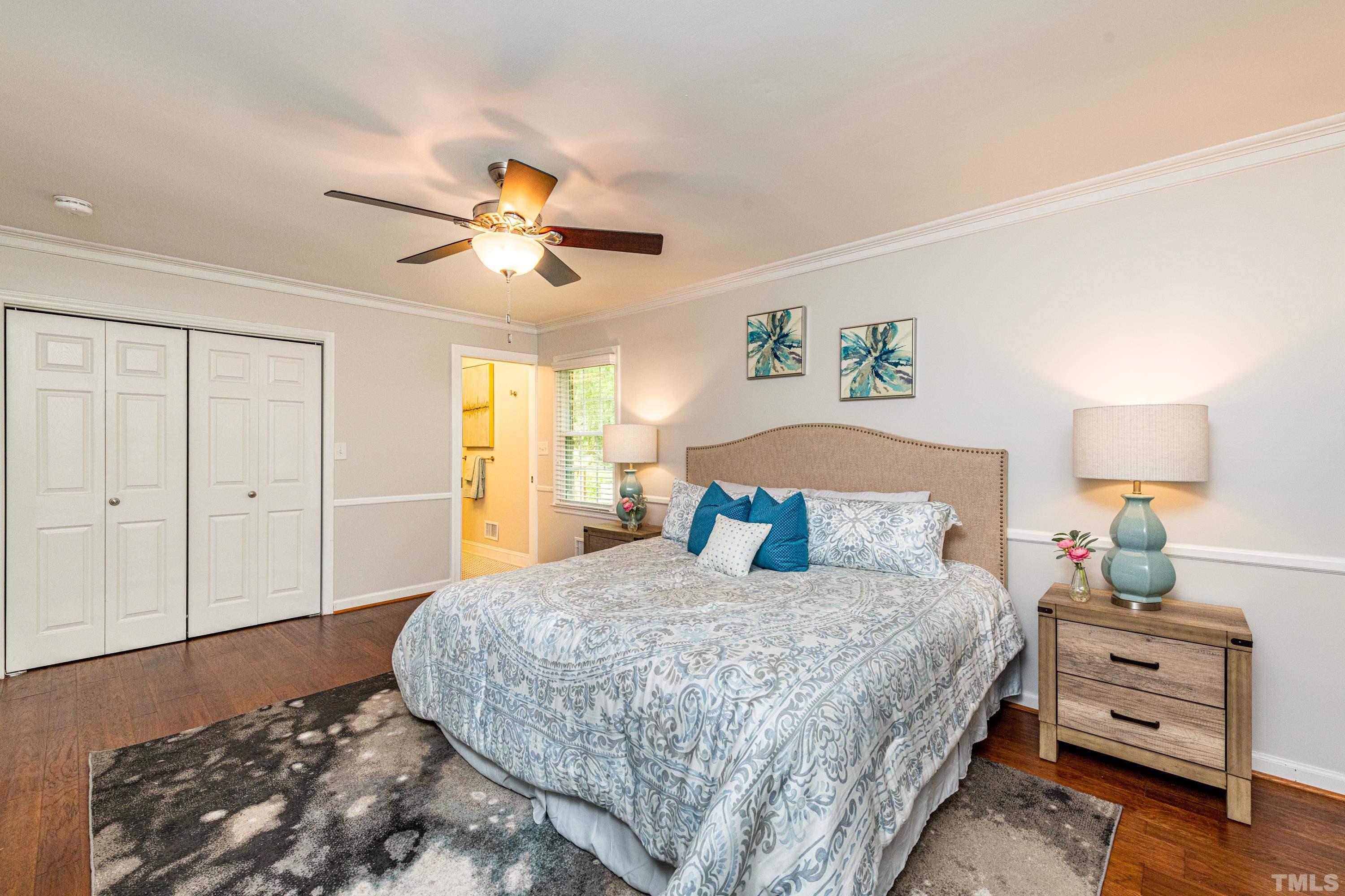 201 Chatterson Drive Raleigh, NC 27615 - Photo 21 of 44 a bedroom with a bed and a chandelier