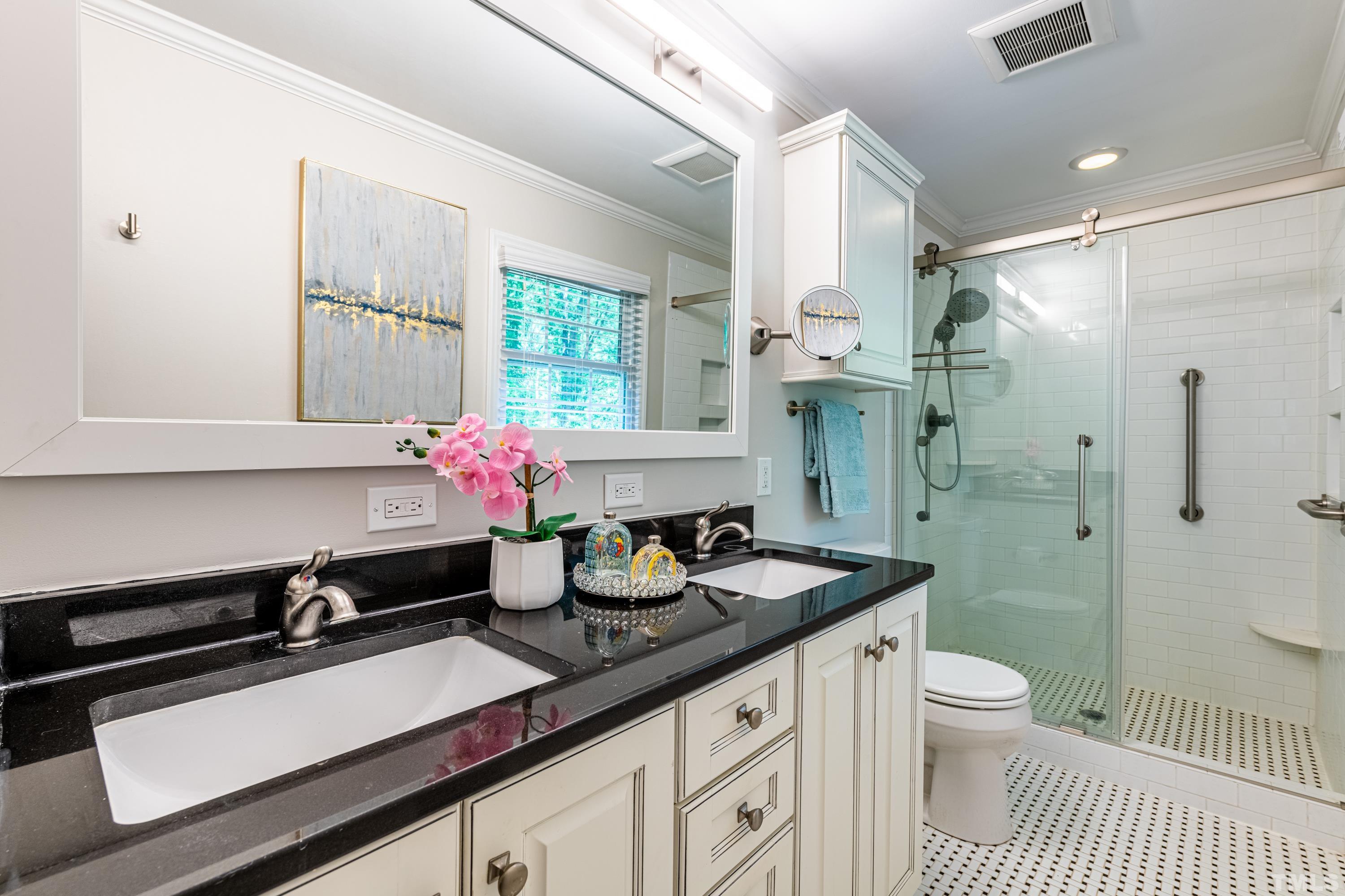201 Chatterson Drive Raleigh, NC 27615 - Photo 22 of 44 a bathroom with a sink a toilet and shower