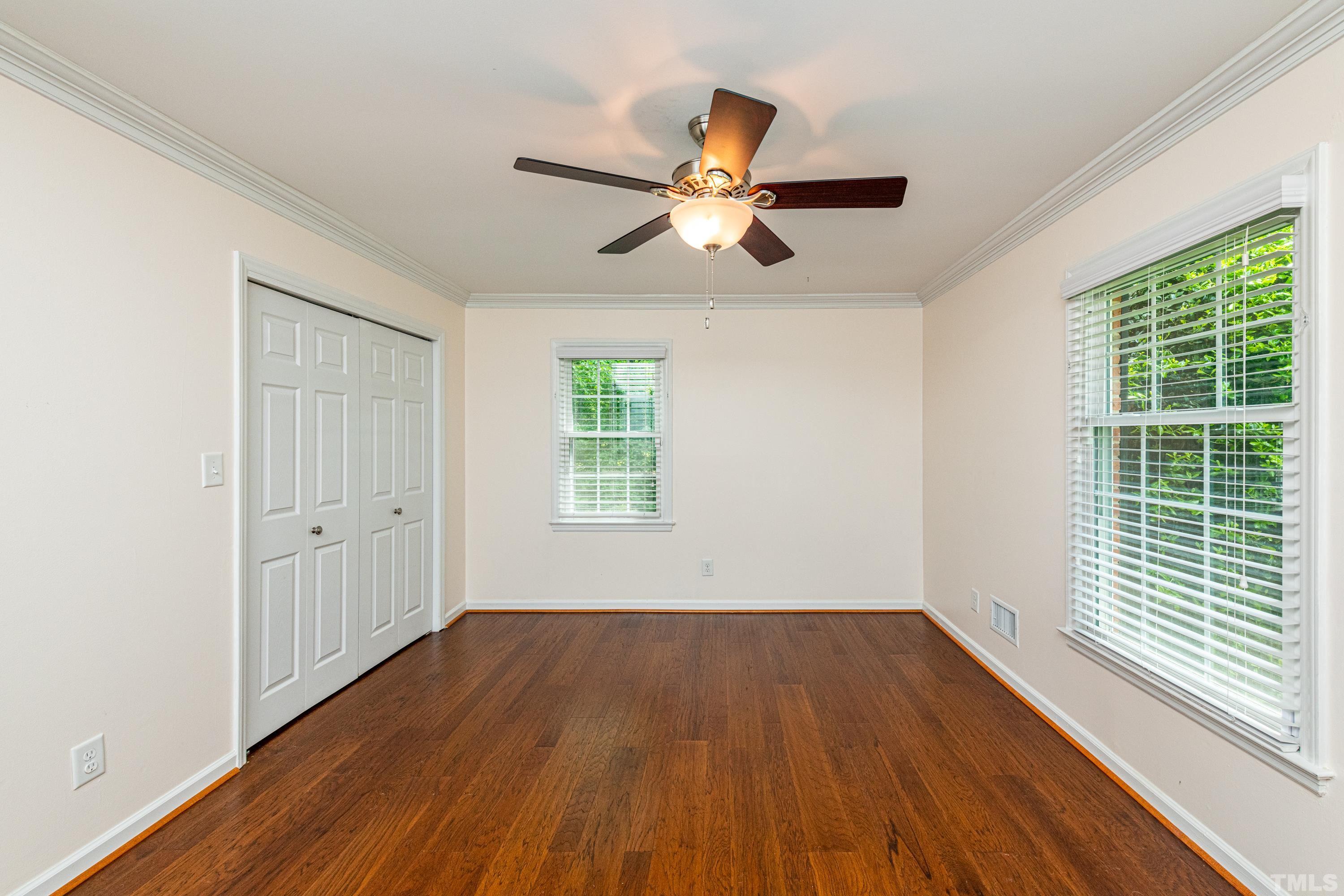 201 Chatterson Drive Raleigh, NC 27615 - Photo 23 of 44 a view of empty room with wooden floor and fan