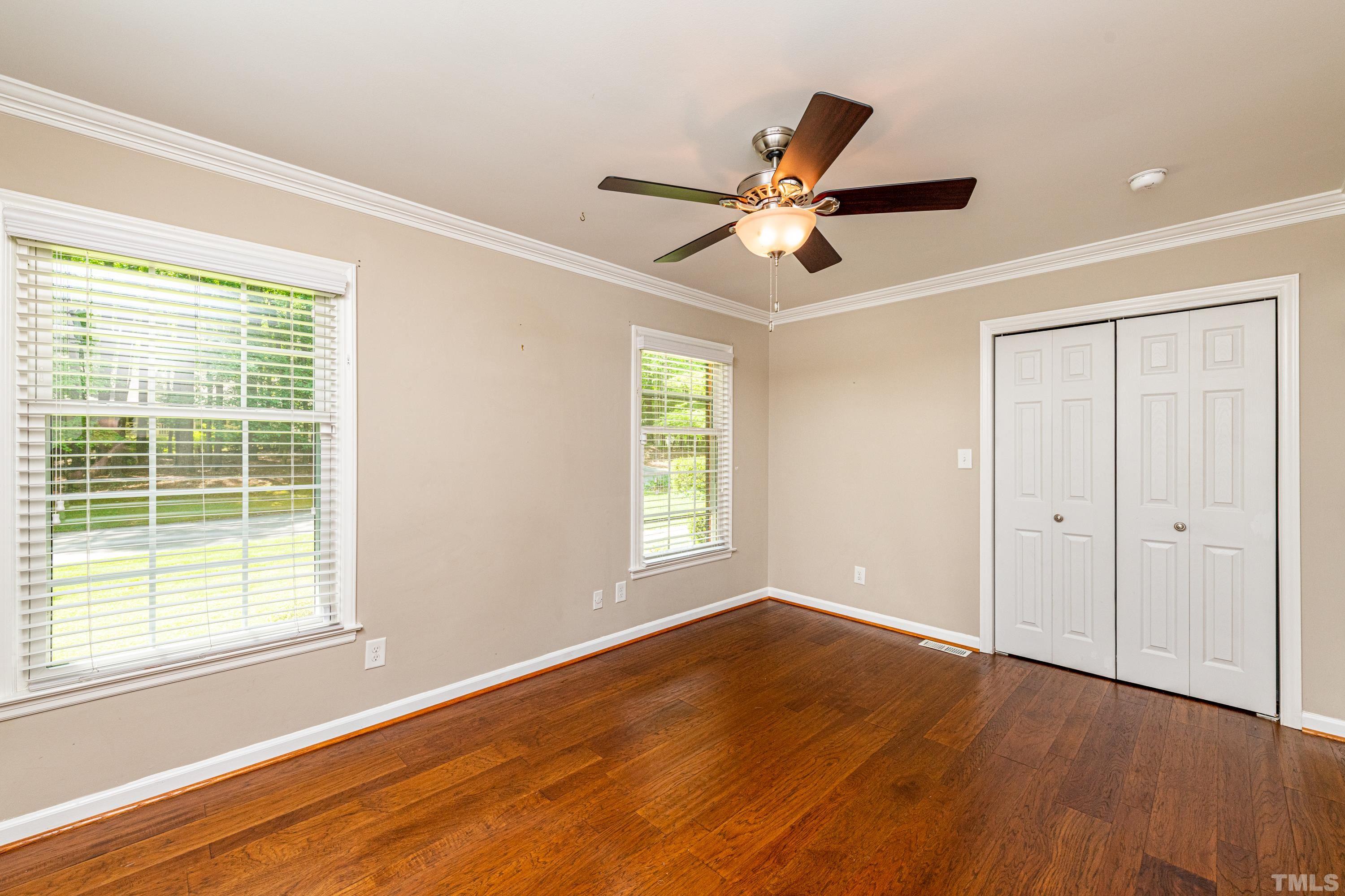 201 Chatterson Drive Raleigh, NC 27615 - Photo 25 of 44 a view of empty room with wooden floor and fan