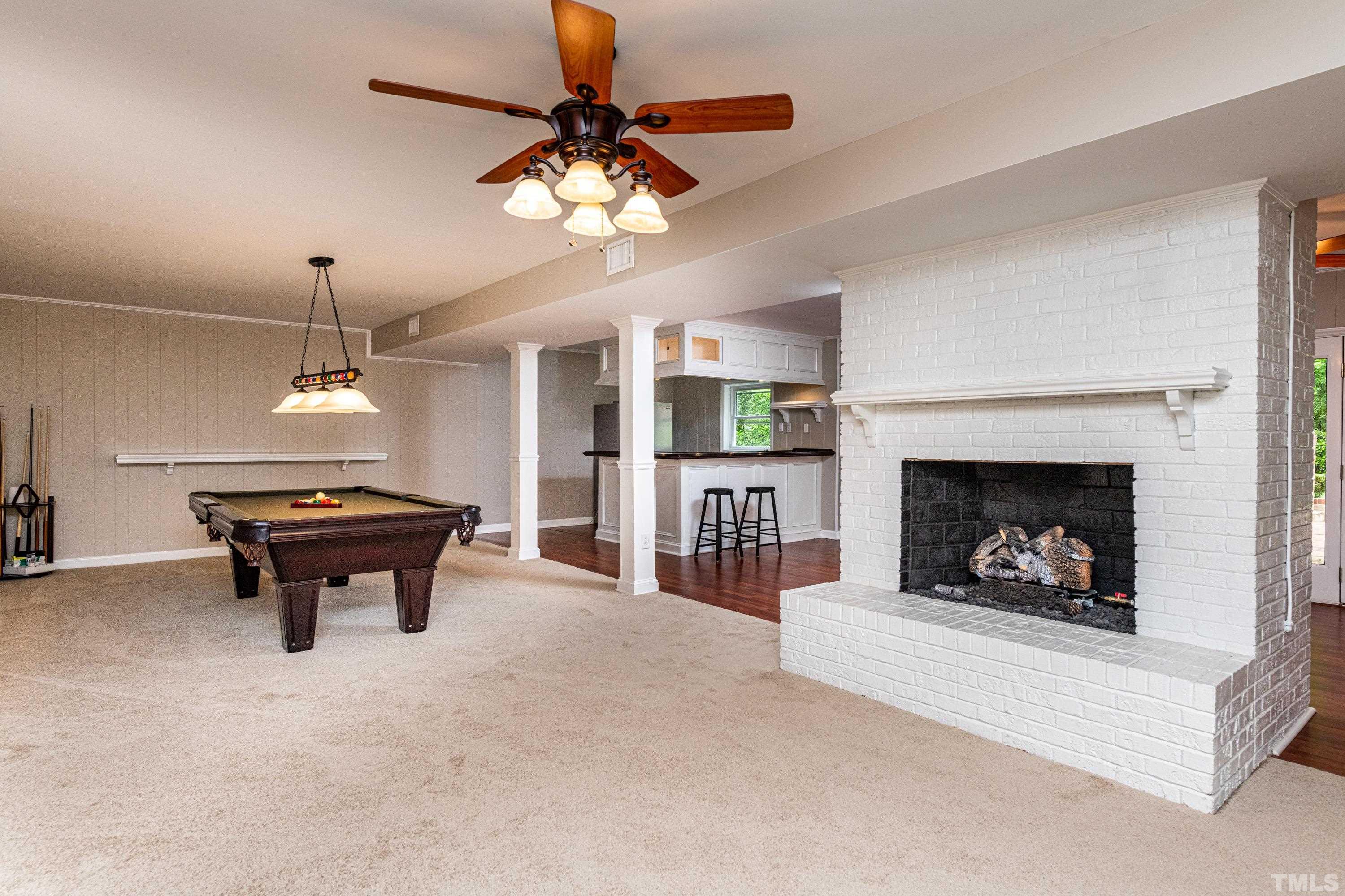 201 Chatterson Drive Raleigh, NC 27615 - Photo 26 of 44 a living room with furniture a chandelier and a fireplace