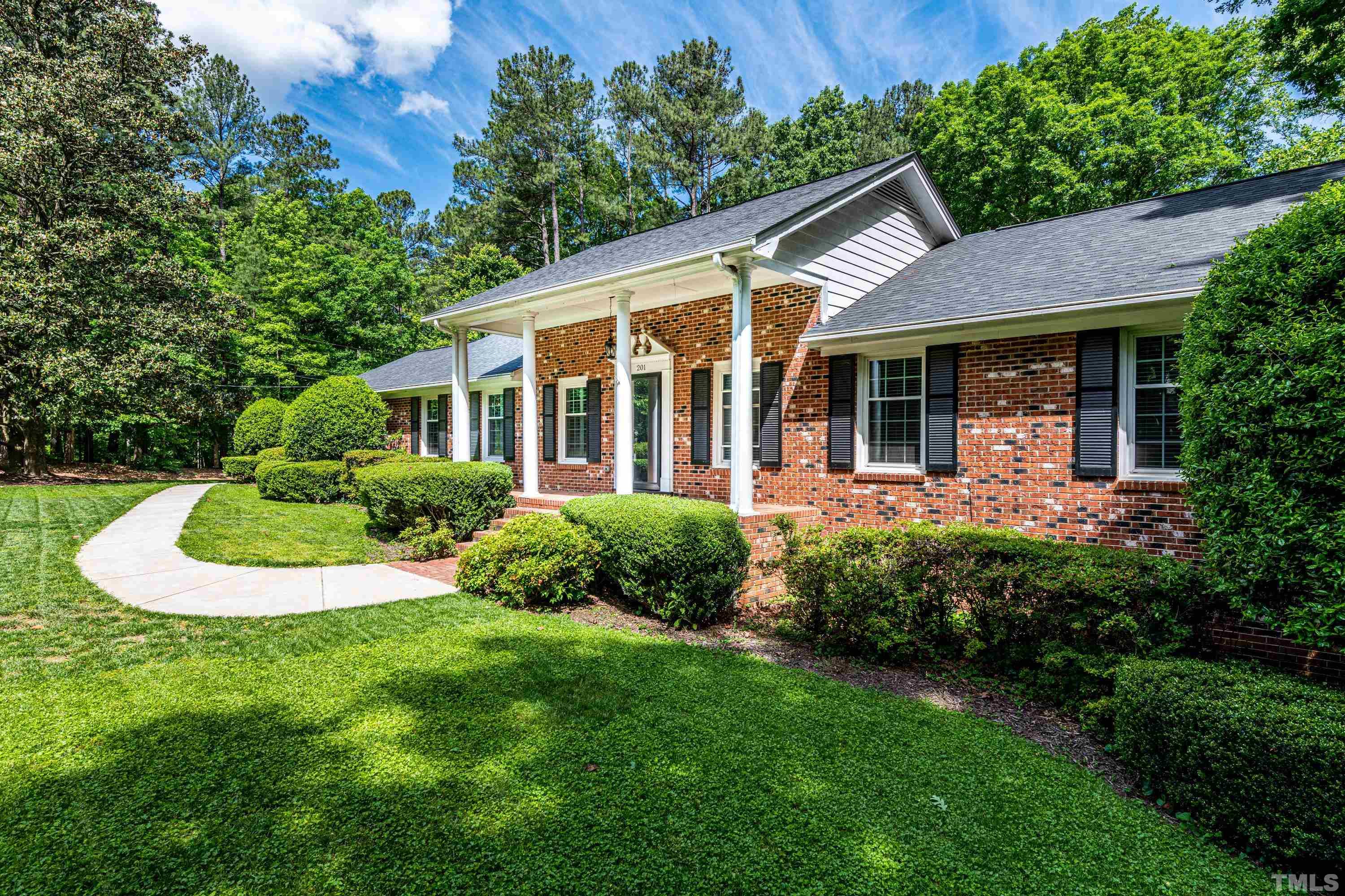201 Chatterson Drive Raleigh, NC 27615 - Photo 3 of 44 a view of a house with a backyard patio and a garden