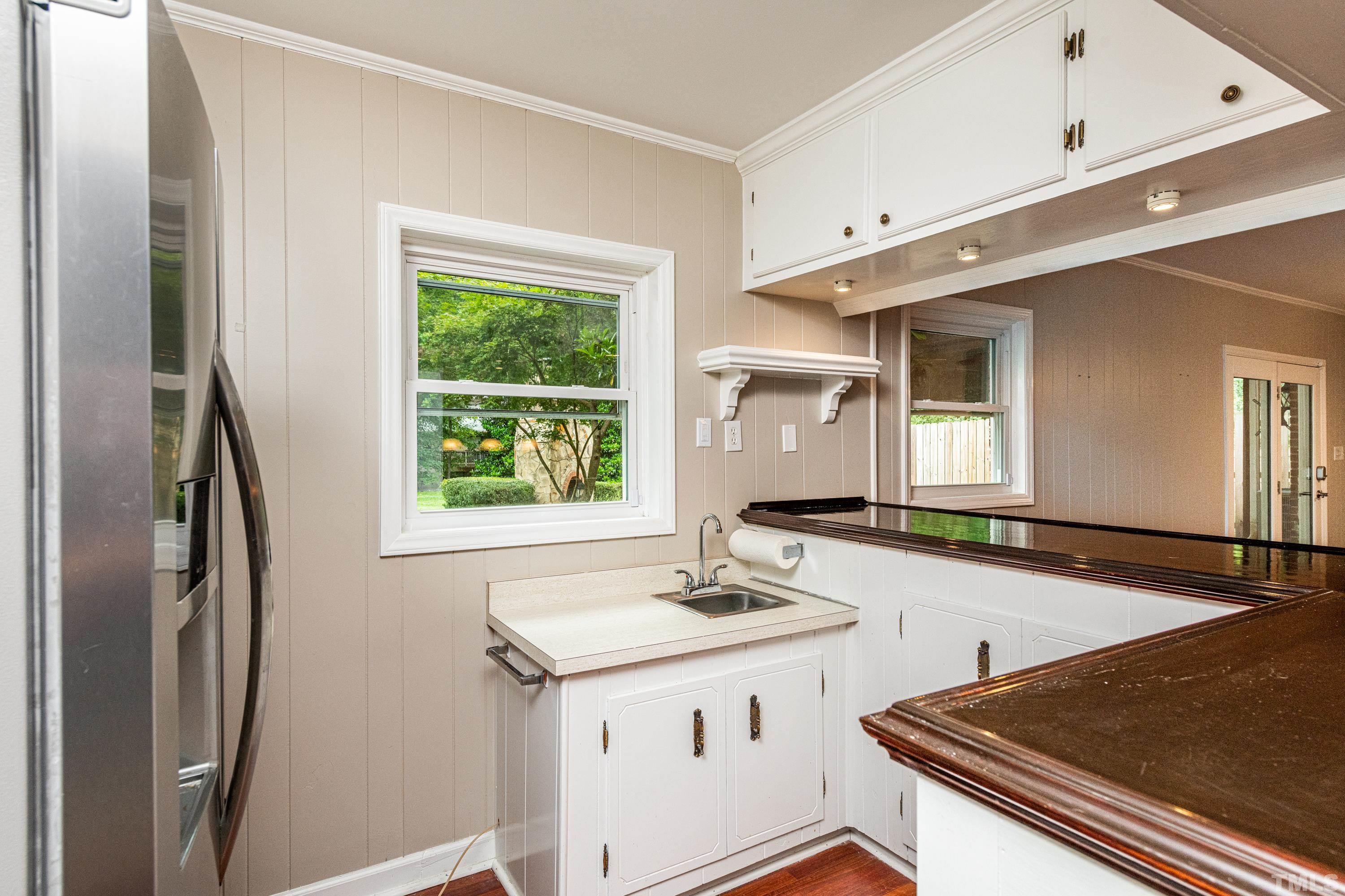 201 Chatterson Drive Raleigh, NC 27615 - Photo 31 of 44 a view of a kitchen with a sink and a window