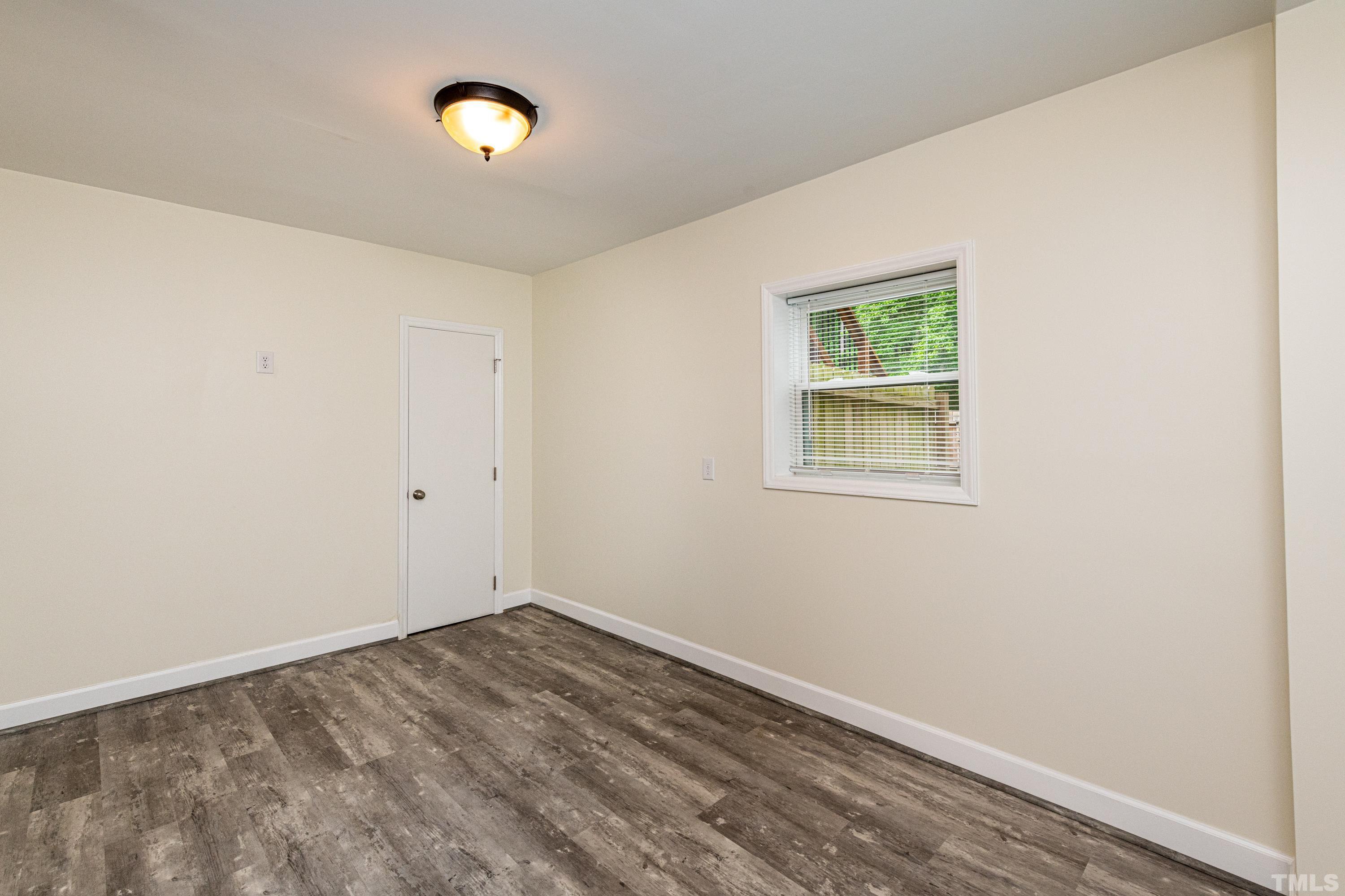 201 Chatterson Drive Raleigh, NC 27615 - Photo 34 of 44 a view of a room with wooden floor and white walls