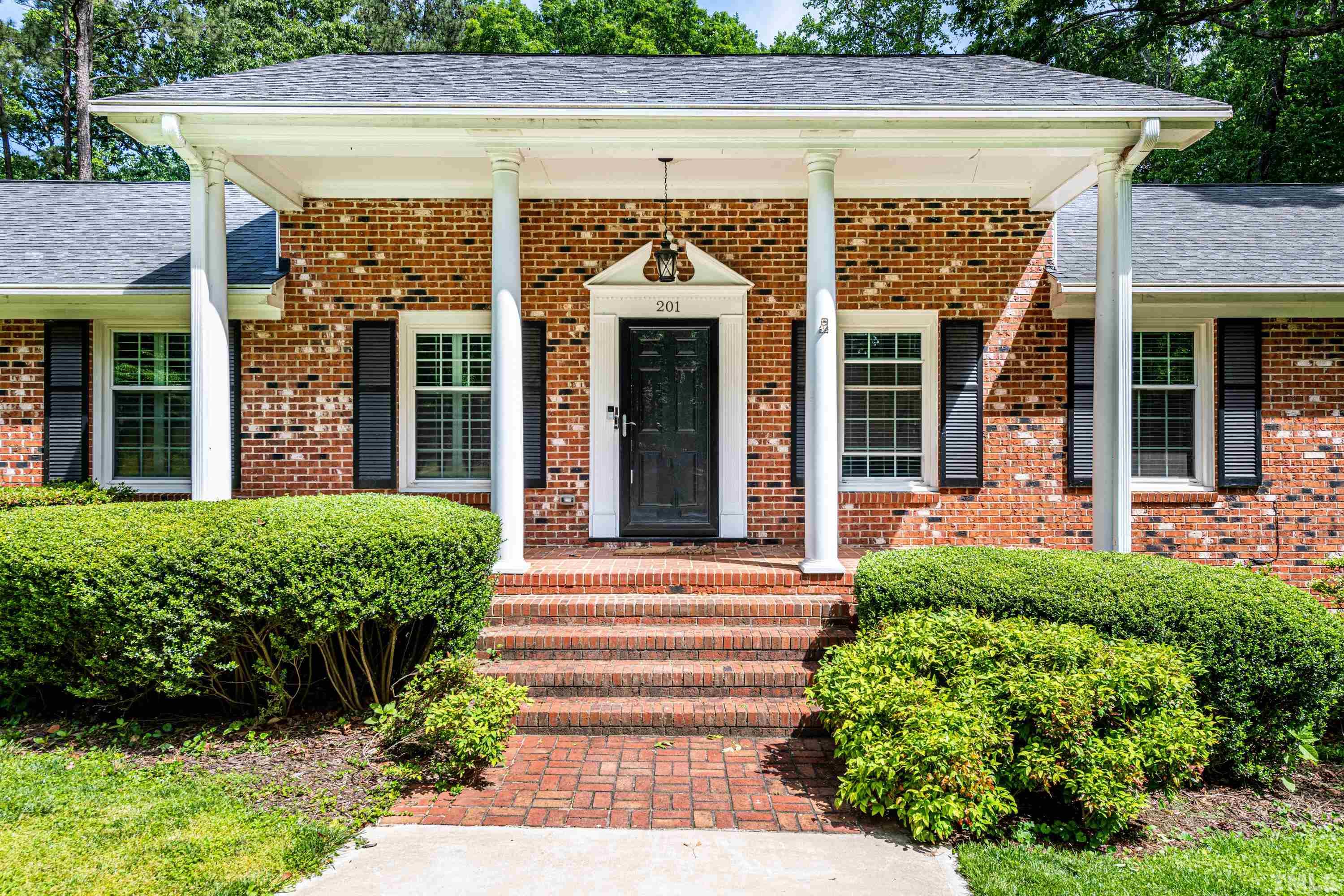 201 Chatterson Drive Raleigh, NC 27615 - Photo 4 of 44 front view of a house with a small porch